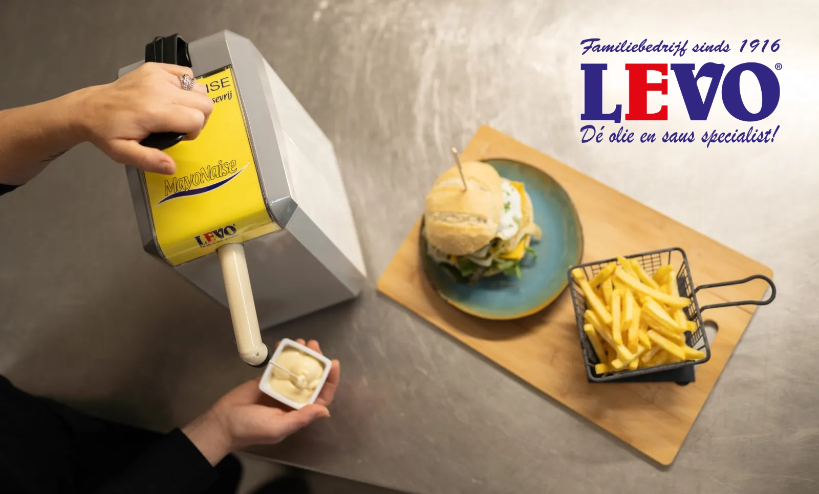 Levo mayonnaise, freshly dispensed from a Levo dispenser next to a burger and crispy fries